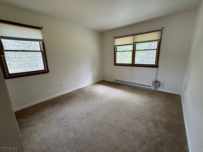 261 Old Chimney Ridge Road, Unit A Montague, NJ 07827 - Photo 19 of 43 an empty room with windows