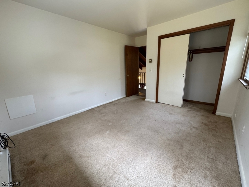 261 Old Chimney Ridge Road, Unit A Montague, NJ 07827 - Photo 21 of 43 an empty room with closet and a hallway