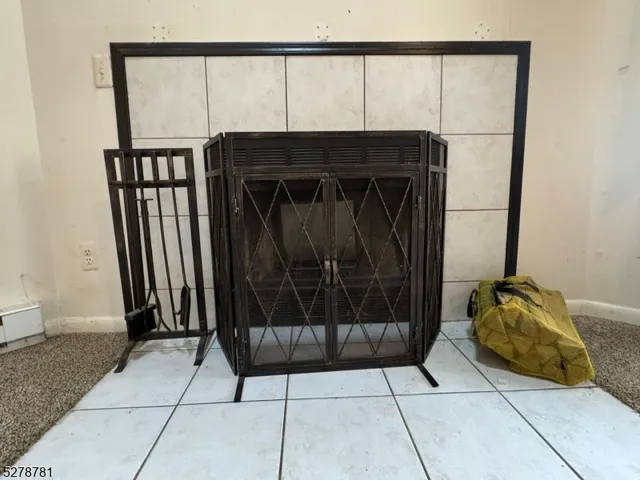 a view of empty room with fireplace