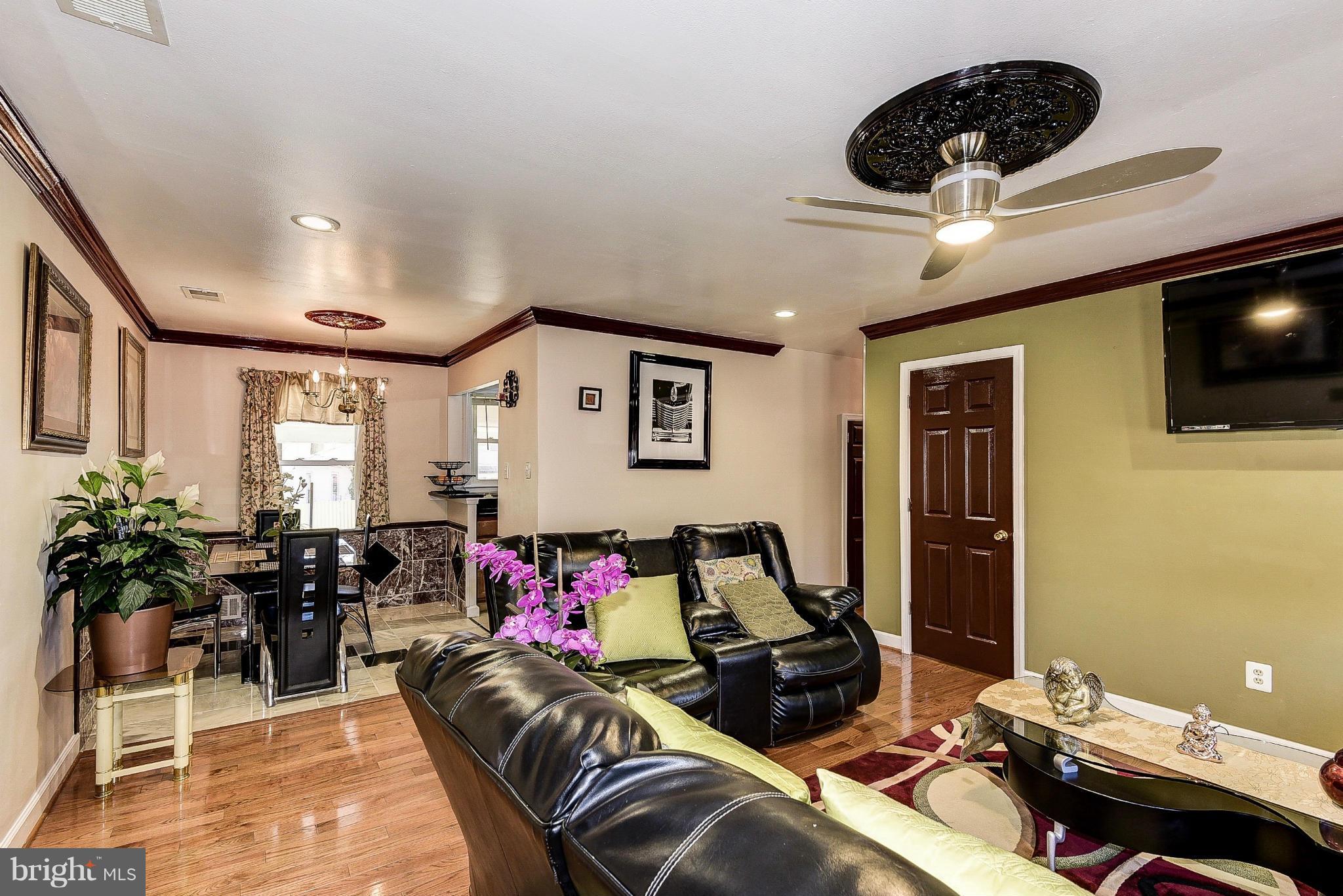 12301 Bluhill Road Silver Spring, MD 20902 - Photo 3 of 13 a living room with furniture and a flat screen tv