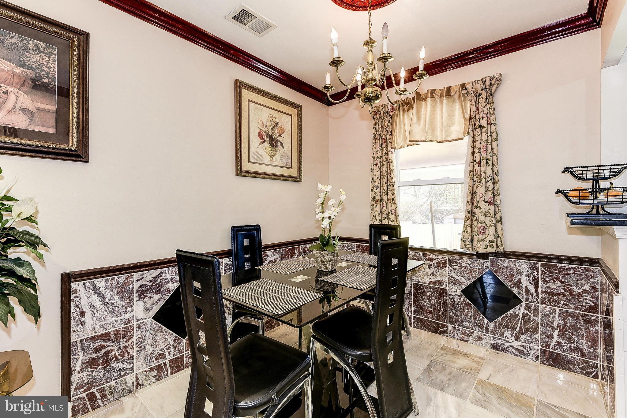 12301 Bluhill Road Silver Spring, MD 20902 - Photo 5 of 13 a view of a dining room with furniture and a chandelier