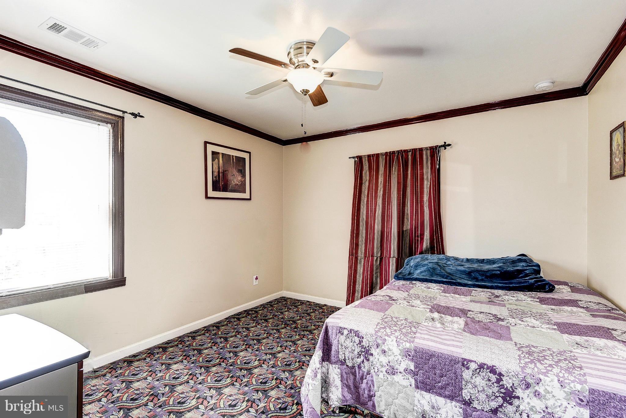 12301 Bluhill Road Silver Spring, MD 20902 - Photo 9 of 13 a bedroom with a bed and a window