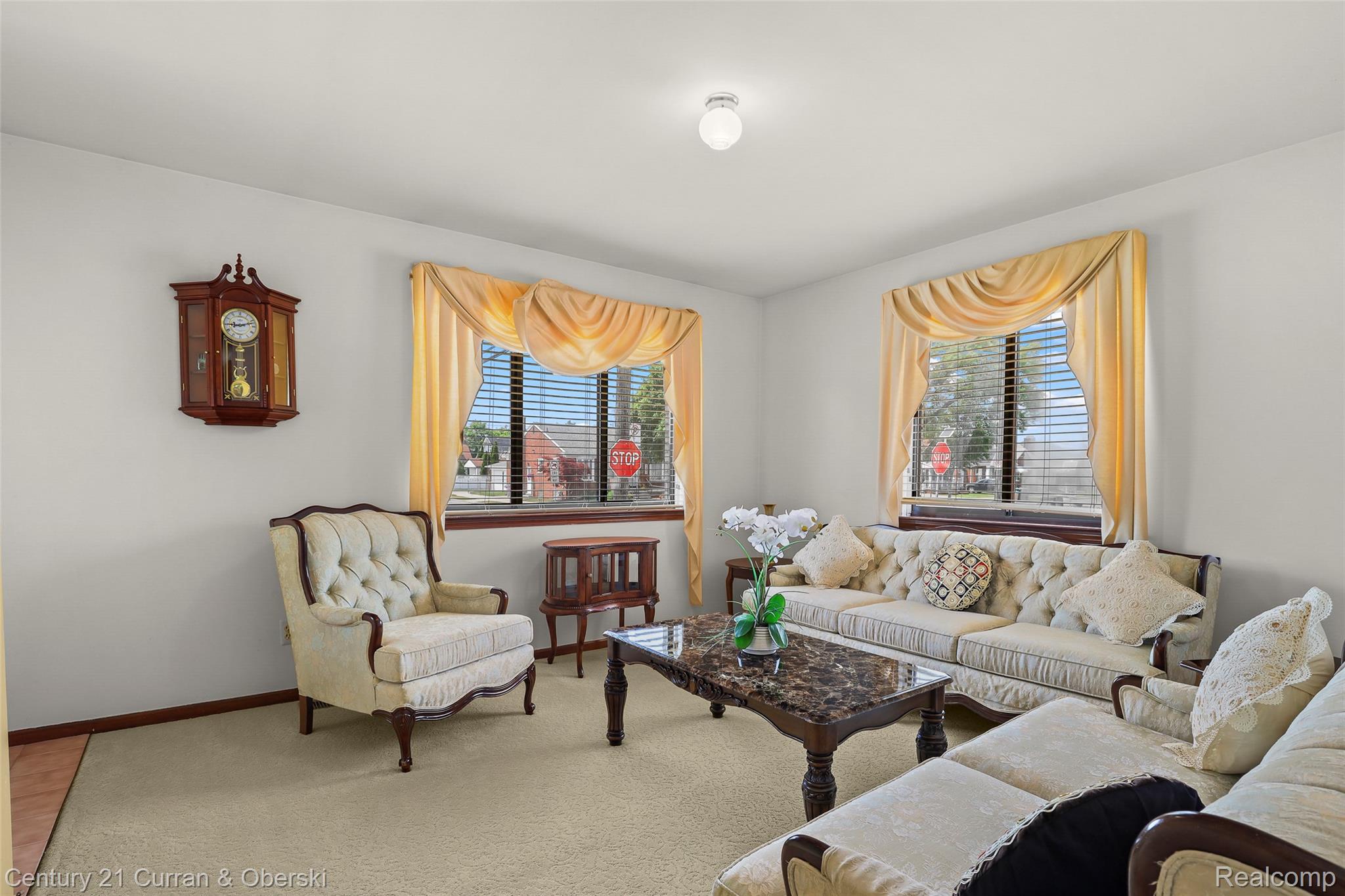 5296 Chase Road Dearborn, MI 48126 - Photo 15 of 36 Bright interior space featuring two large windows with blinds, light wall paint, and a ceiling-mounted light fixture