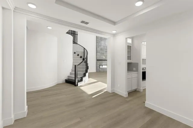 a view of a room with wooden floor and entryway