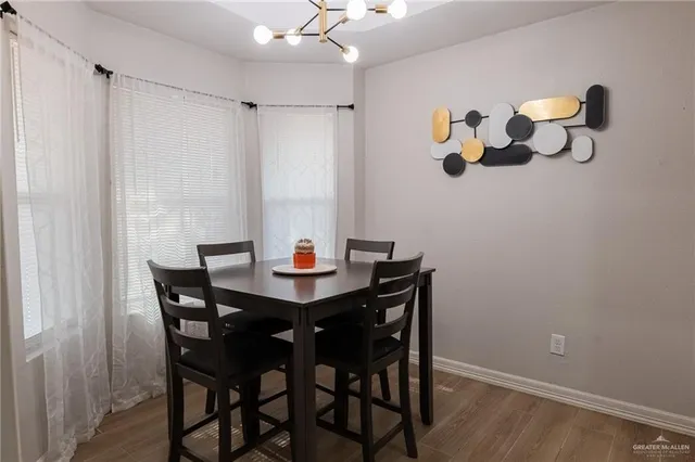 a view of a dining room with furniture and chandelier