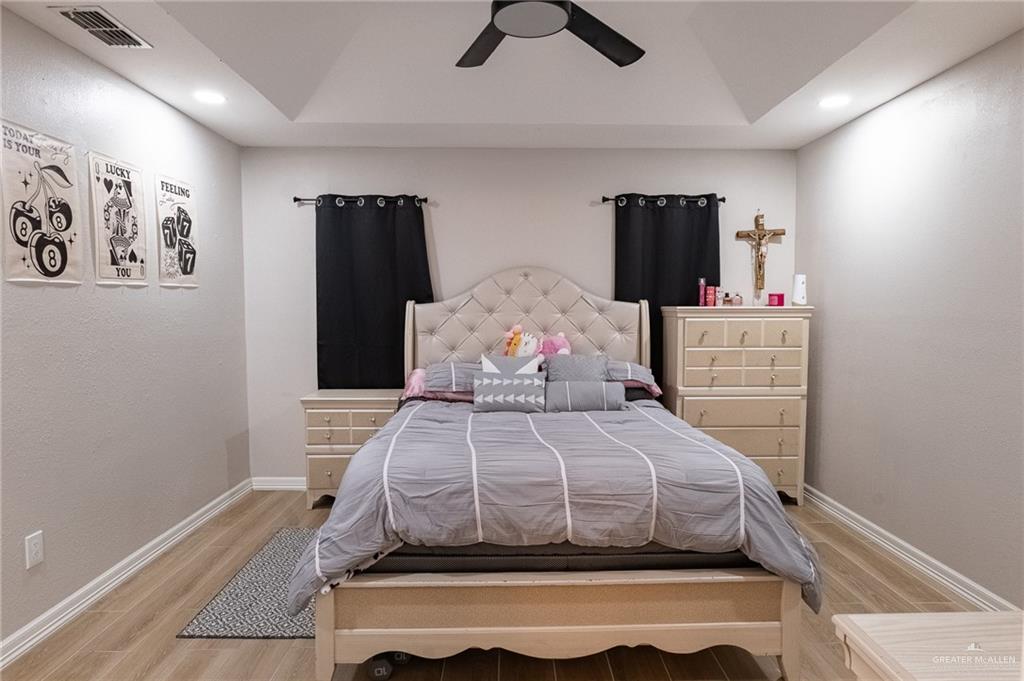 101 Apollo Drive Donna, TX 78537 - Photo 10 of 11 a bedroom with a bed and wooden floor