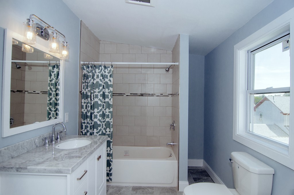 16 Port Norfolk Street, Unit 2 Boston, MA 02122 - Photo 11 of 13 a bathroom with a granite countertop sink toilet and shower
