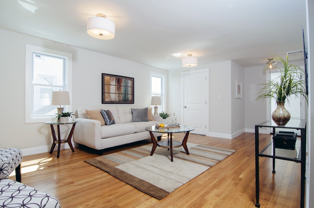 16 Port Norfolk Street, Unit 2 Boston, MA 02122 - Photo 2 of 13 a living room with furniture and wooden floor