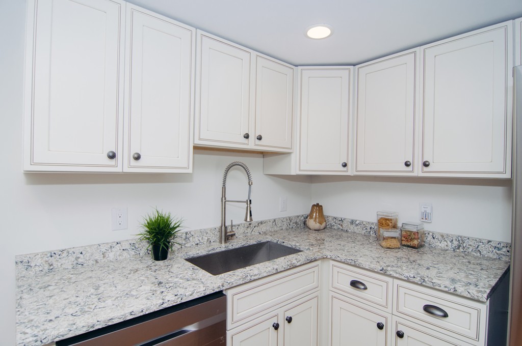 16 Port Norfolk Street, Unit 2 Boston, MA 02122 - Photo 6 of 13 a kitchen with granite countertop white cabinets and white appliances