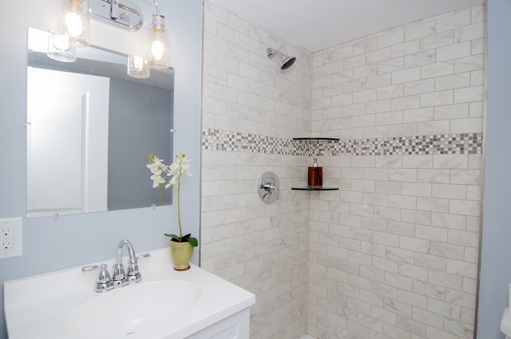 16 Port Norfolk Street, Unit 2 Boston, MA 02122 - Photo 10 of 13 a bathroom with a sink a mirror and shower