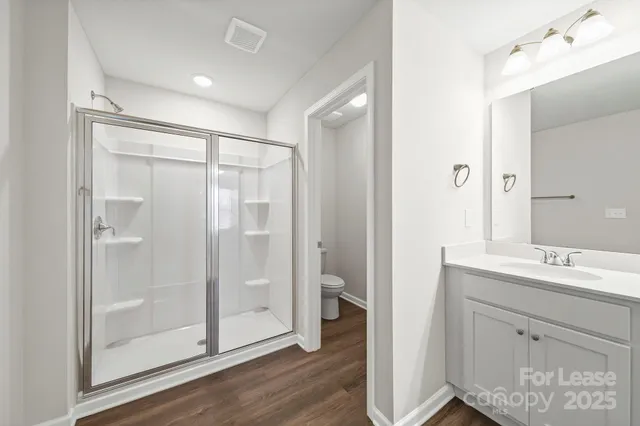 a bathroom with a shower sink and mirror