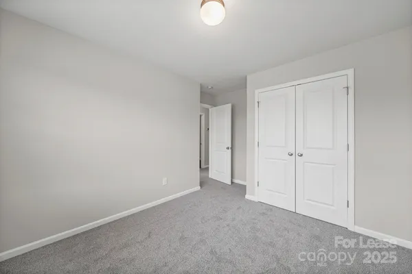 a view of an empty room and closet area