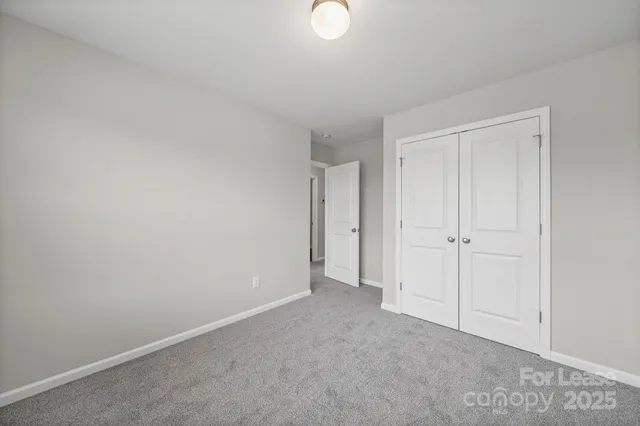 a view of an empty room and closet area