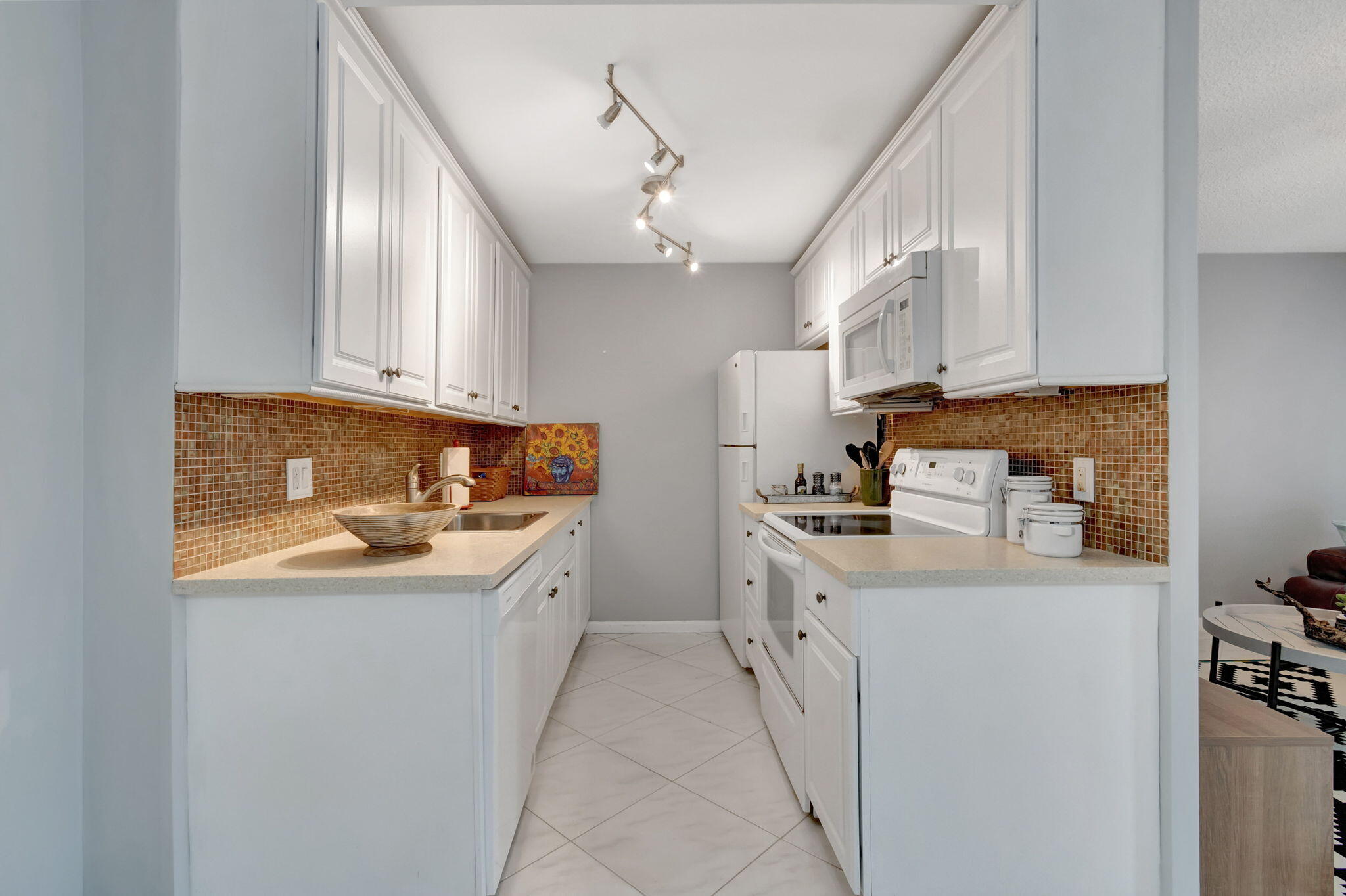 3031 Cornwall East Boca Raton, FL 33434 - Photo 12 of 84 a kitchen with a sink stove and cabinets