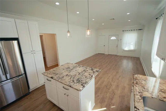 a view of kitchen island wooden floor furniture and a window