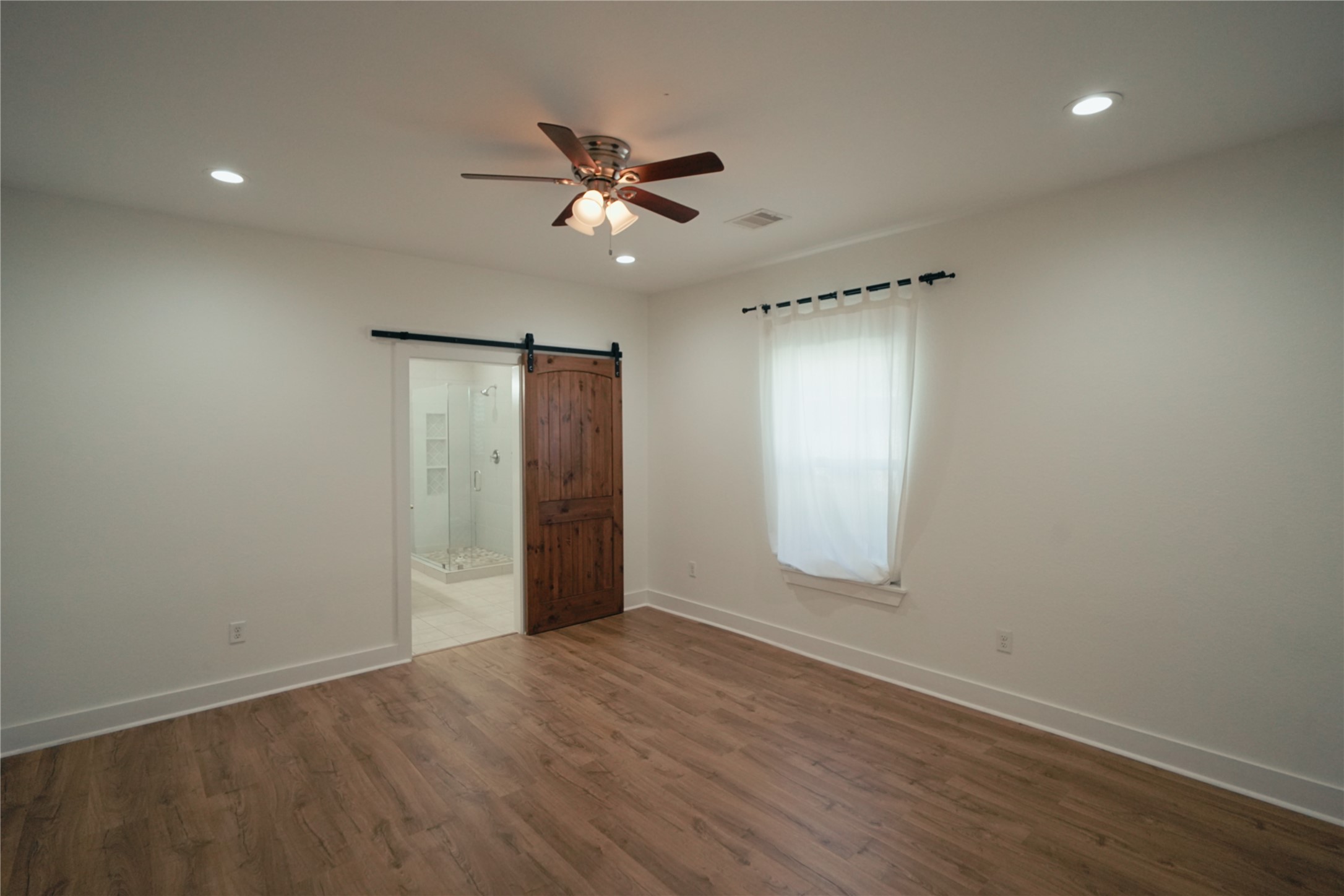 5105 Chapman Street Houston, TX 77009 - Photo 12 of 49 an empty room with wooden floor closet and fan