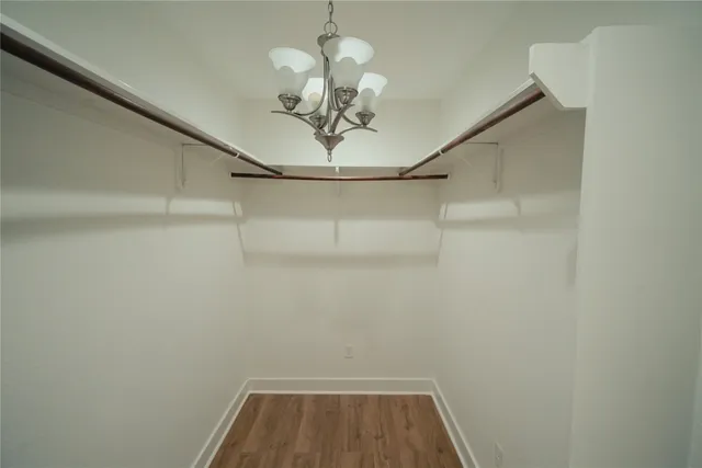 a view of a hallway with a chandelier fan