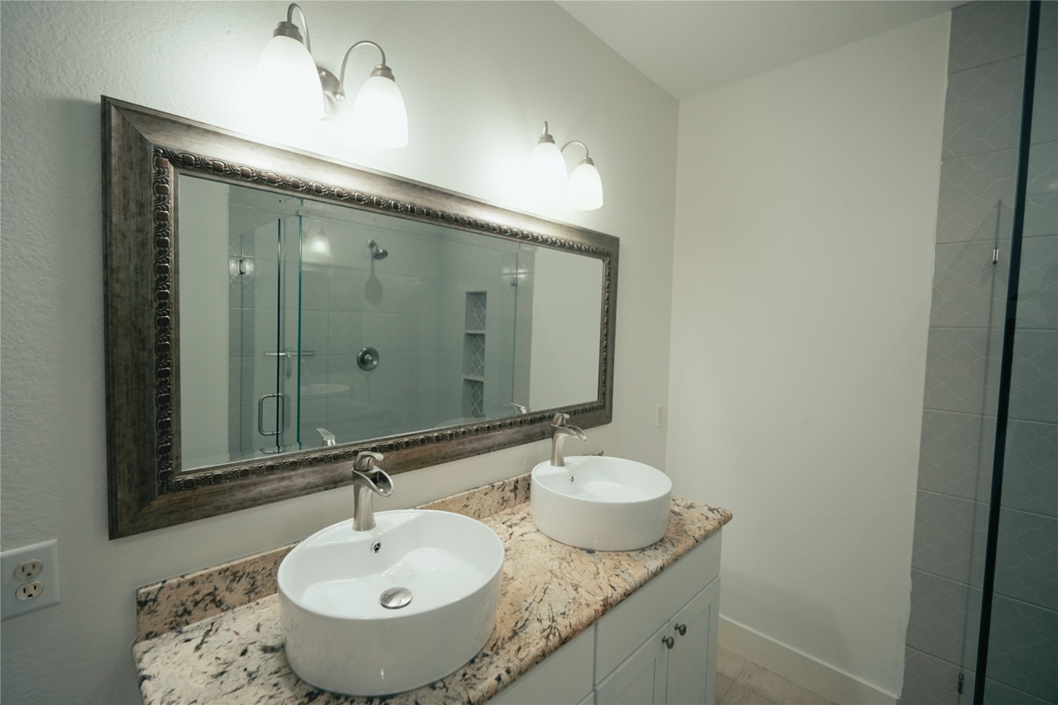 5105 Chapman Street Houston, TX 77009 - Photo 19 of 49 a bathroom with a granite countertop sink and a mirror
