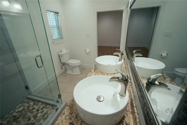 a bathroom with a sink a toilet and a mirror