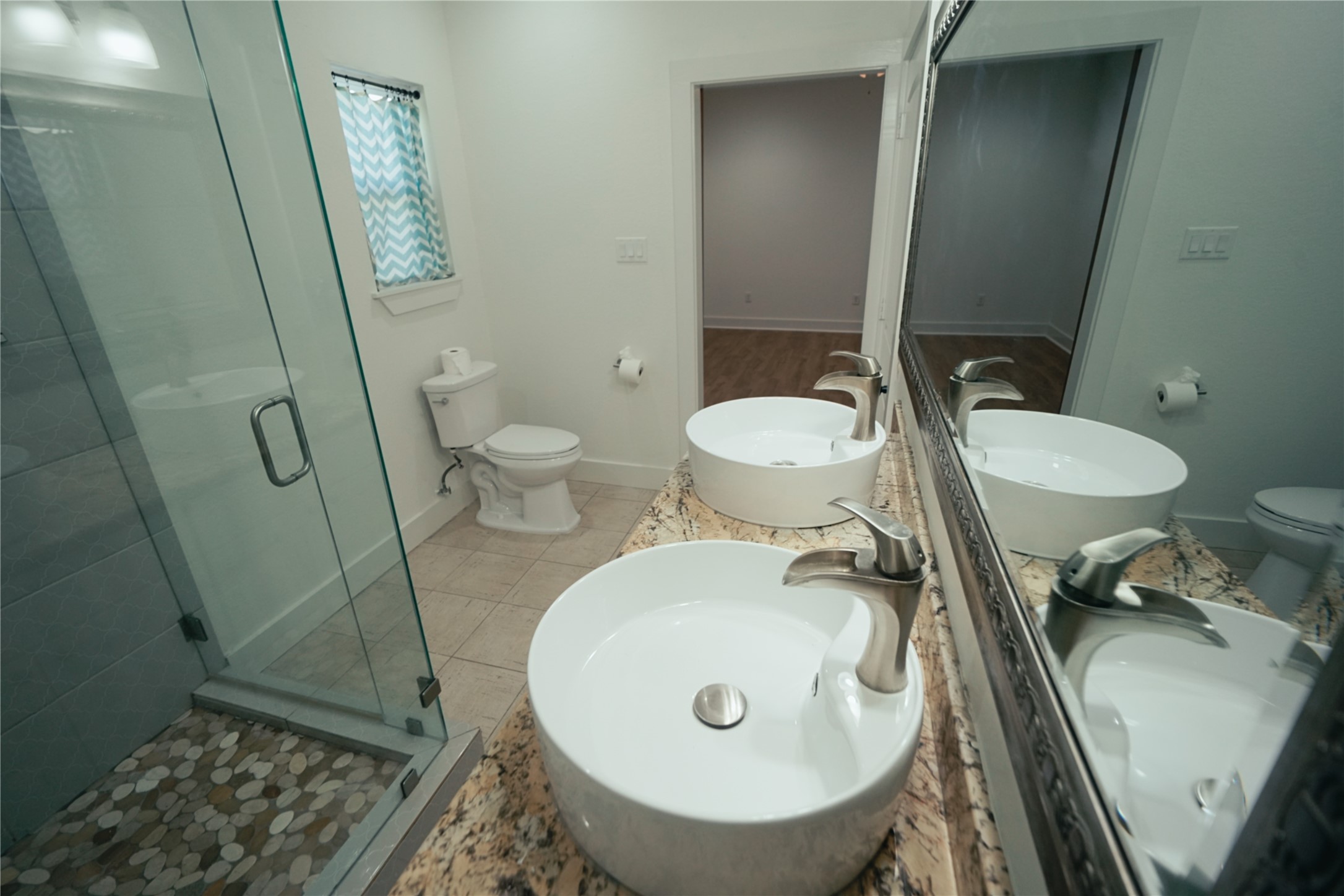 5105 Chapman Street Houston, TX 77009 - Photo 20 of 49 a bathroom with a sink a toilet and a mirror