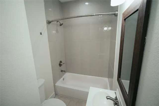 a bathroom with a tub and shower