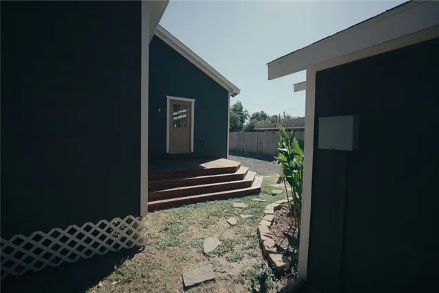 a wooden bench sitting in front of a door