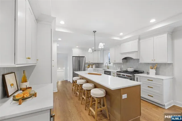 a kitchen with a sink a stove and cabinets
