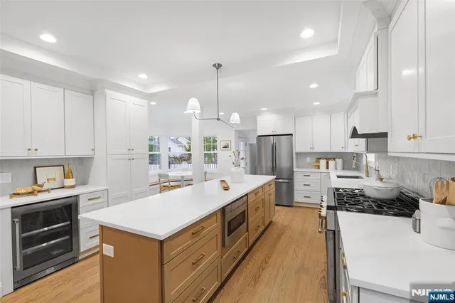 a kitchen with a stove sink and a refrigerator