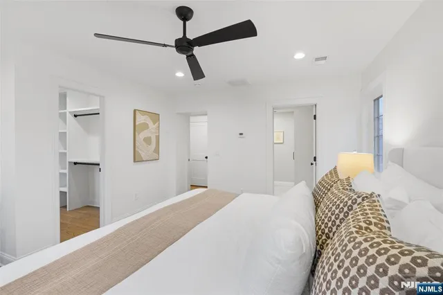 a bedroom with a bed and a painting on the wall