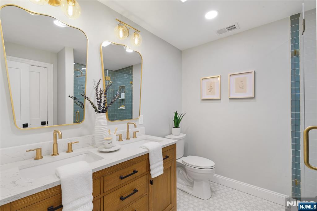 222 Ridge Road Rutherford, NJ 07070 - Photo 20 of 46 a bathroom with a granite countertop toilet sink and mirror