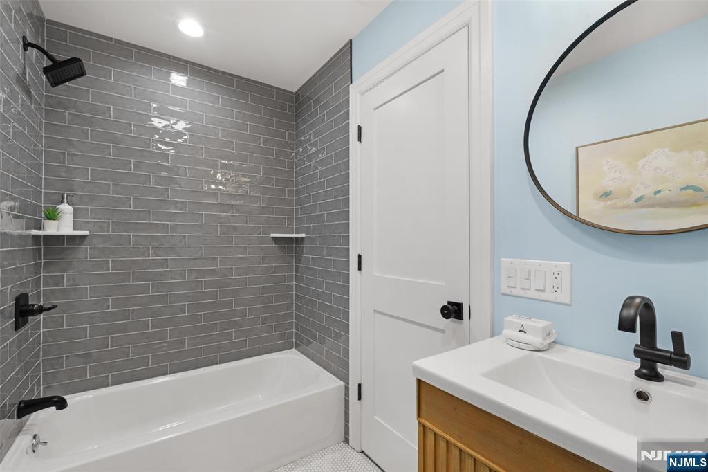 222 Ridge Road Rutherford, NJ 07070 - Photo 26 of 46 a bathroom with a sink and a mirror