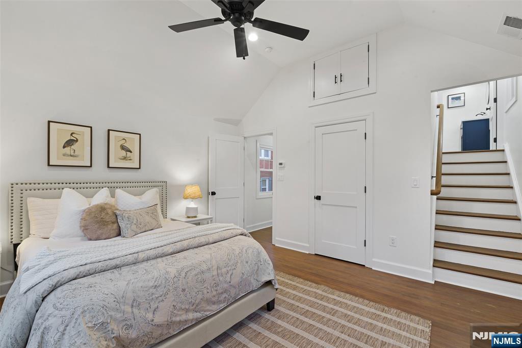 222 Ridge Road Rutherford, NJ 07070 - Photo 27 of 46 a bedroom with a bed and a chandelier