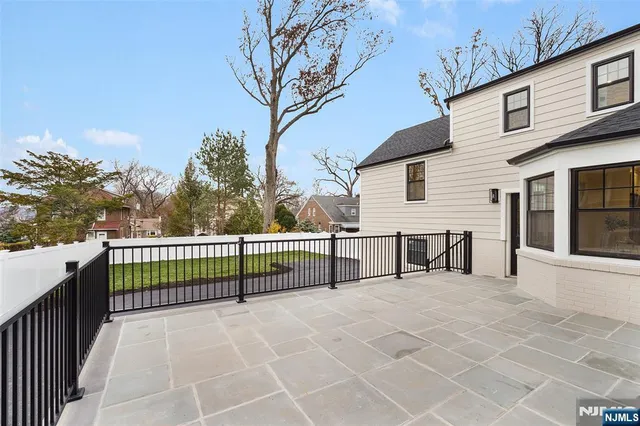 a view of a house with a wooden fence