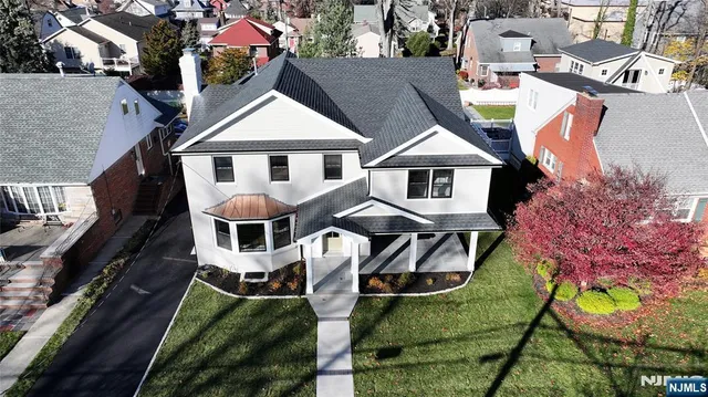 an aerial view of a house with garden space and street view
