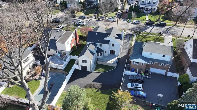 an aerial view of a house with a yard basket ball court and outdoor seating
