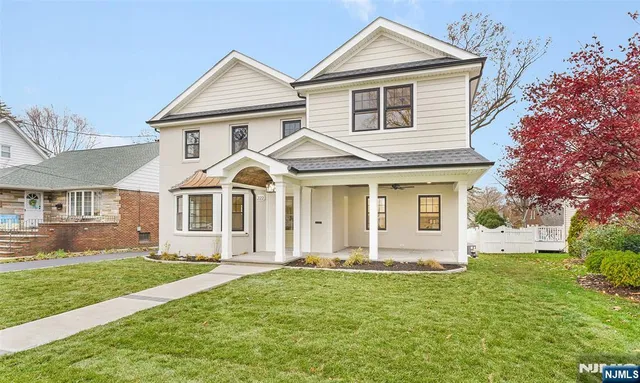 a front view of a house with a garden and yard