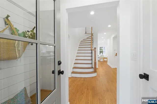 a view of a hallway with wooden floor and windows