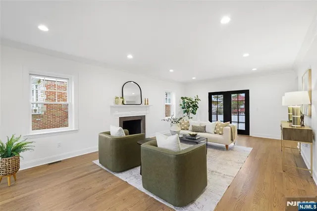a living room with fireplace furniture and a wooden floor