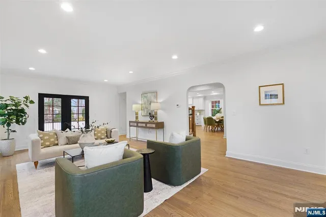 a living room with fireplace furniture and a wooden floor