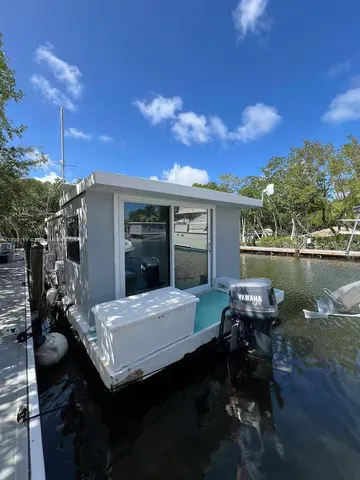 an aerial view of a house with a yard and lake view