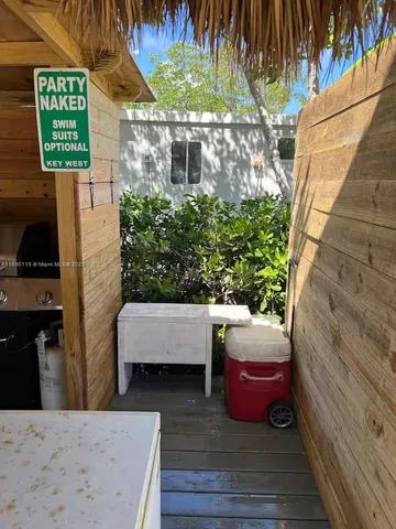 a view of a dry yard with wooden fence