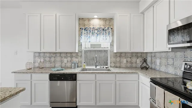 a kitchen with a sink and cabinets