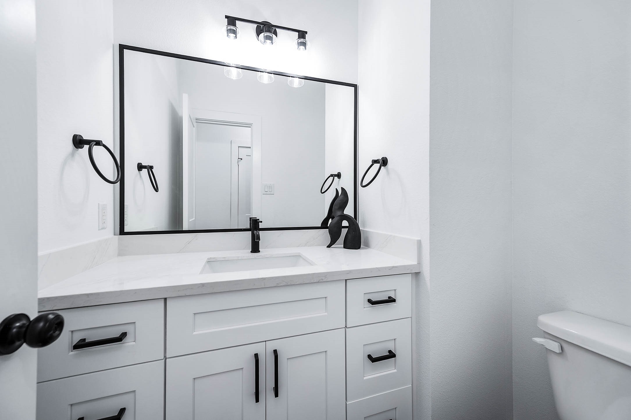 1515 Euel Street Houston, TX 77009 - Photo 16 of 34 Stylish bathroom vanity with modern fixtures, sleek hardware, and a large mirror that enhances the bright and polished look.