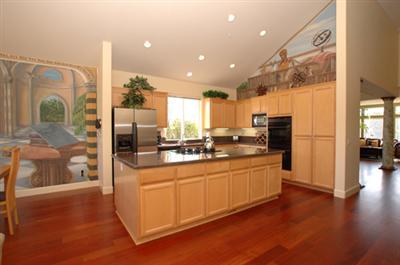 43 Montevideo Way San Rafael, CA 94903 - Photo 8 of 12 a kitchen with stainless steel appliances granite countertop a refrigerator a sink and a stove with wooden floor