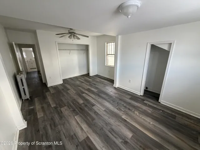 wooden floor in an empty room with a mirror