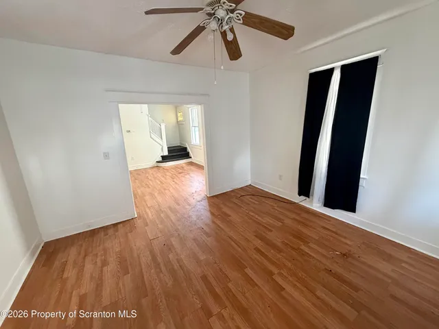wooden floor in an empty room with a window