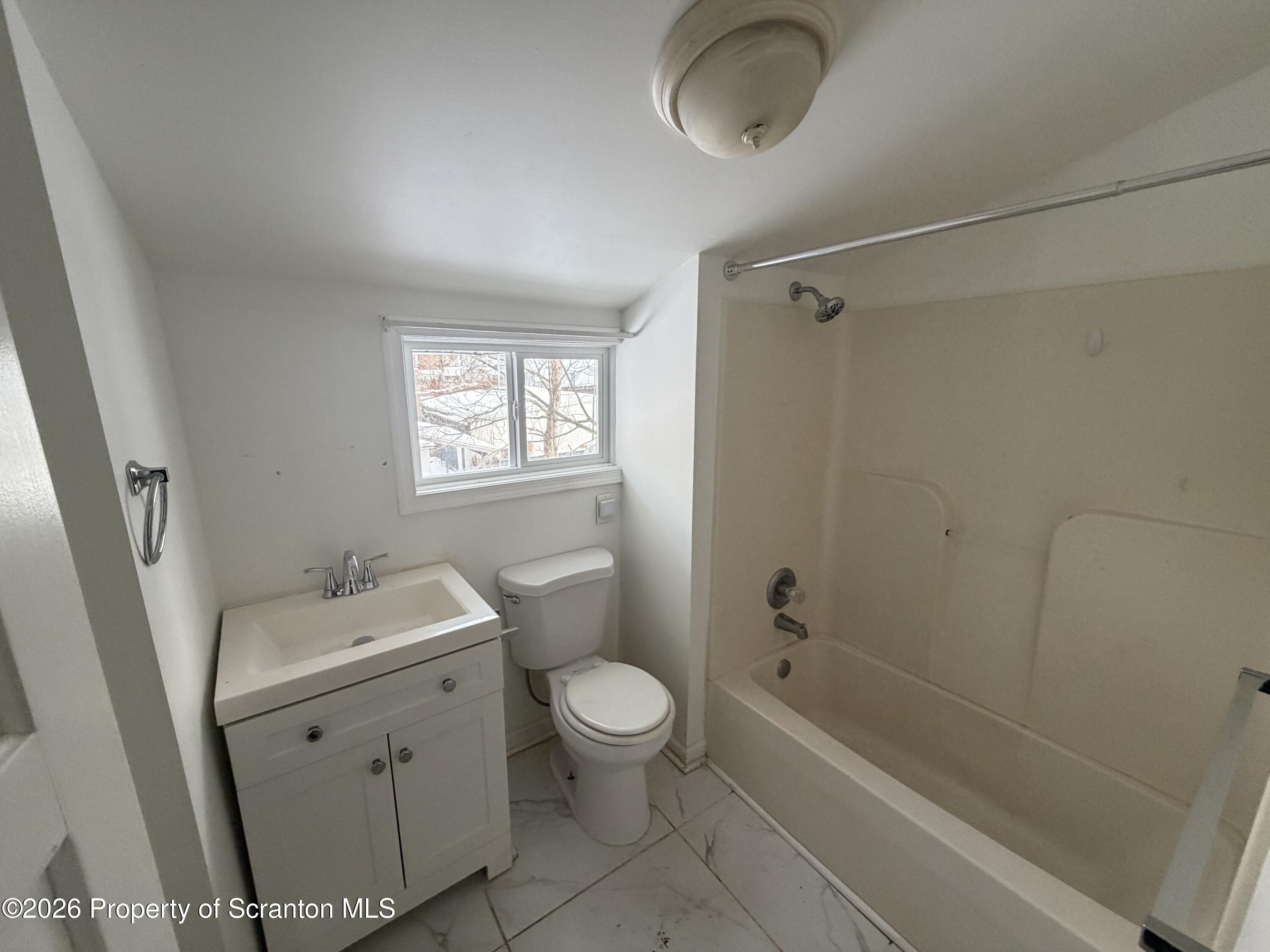 202 William Street Scranton, PA 18508 - Photo 8 of 11 a bathroom with a sink a toilet and shower