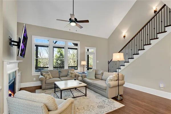 a bedroom with a bed and a large window with wooden floor