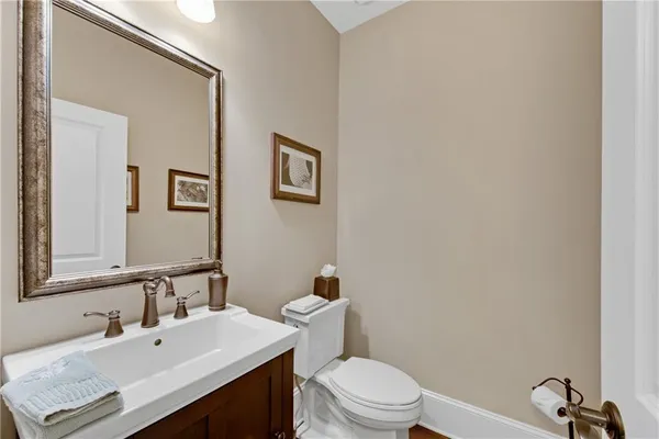 a kitchen with stainless steel appliances kitchen island granite countertop a table chairs and a refrigerator