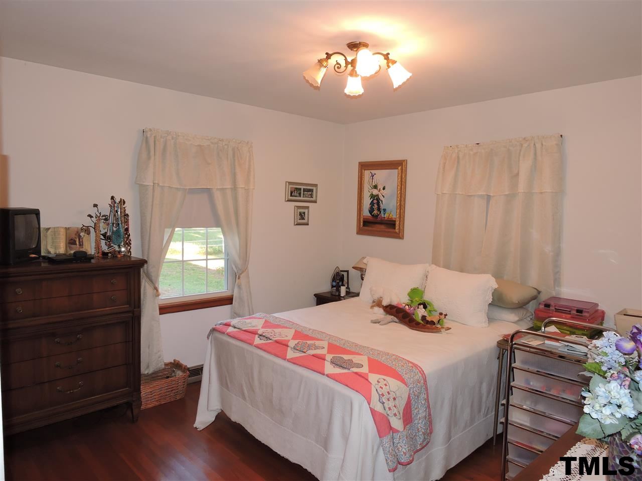 910 Antioch Church Road Timberlake, NC 27583 - Photo 8 of 22 a bedroom with a bed and wooden floor